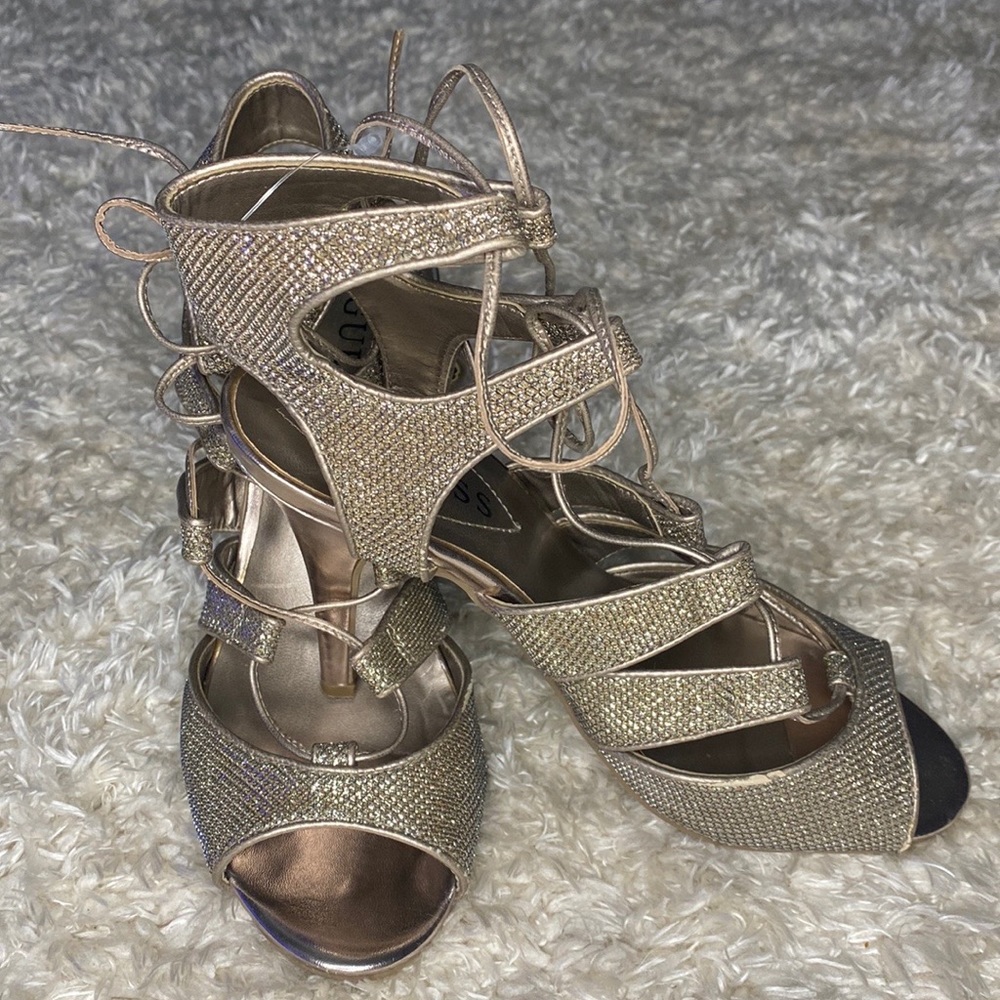 Gold lace up dressy heels.